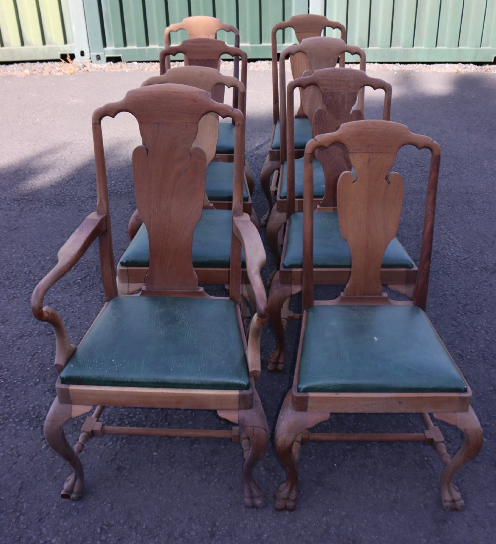 A set of eight Queen Anne style timber dining chairs featuring green leather seats, carved vase splat backs, and cabriole legs ending in claw and ball feet. View II
