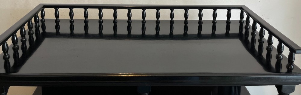 A late Victorian ebonised wood cabinet with a top spindle gallery, dark mahogany panels, and a central door featuring a profile ceramic tile of Dante. View VII