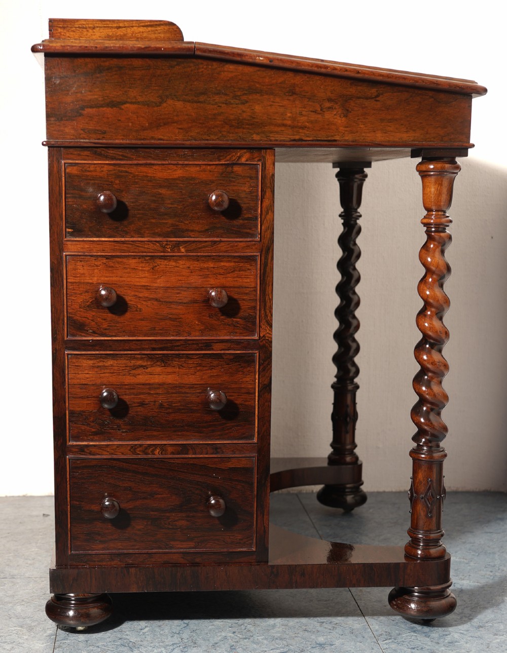 A Victorian rosewood Davenport desk featuring barley twist front supports, side drawers with wooden knob handles, and a hinged slanted top. View III