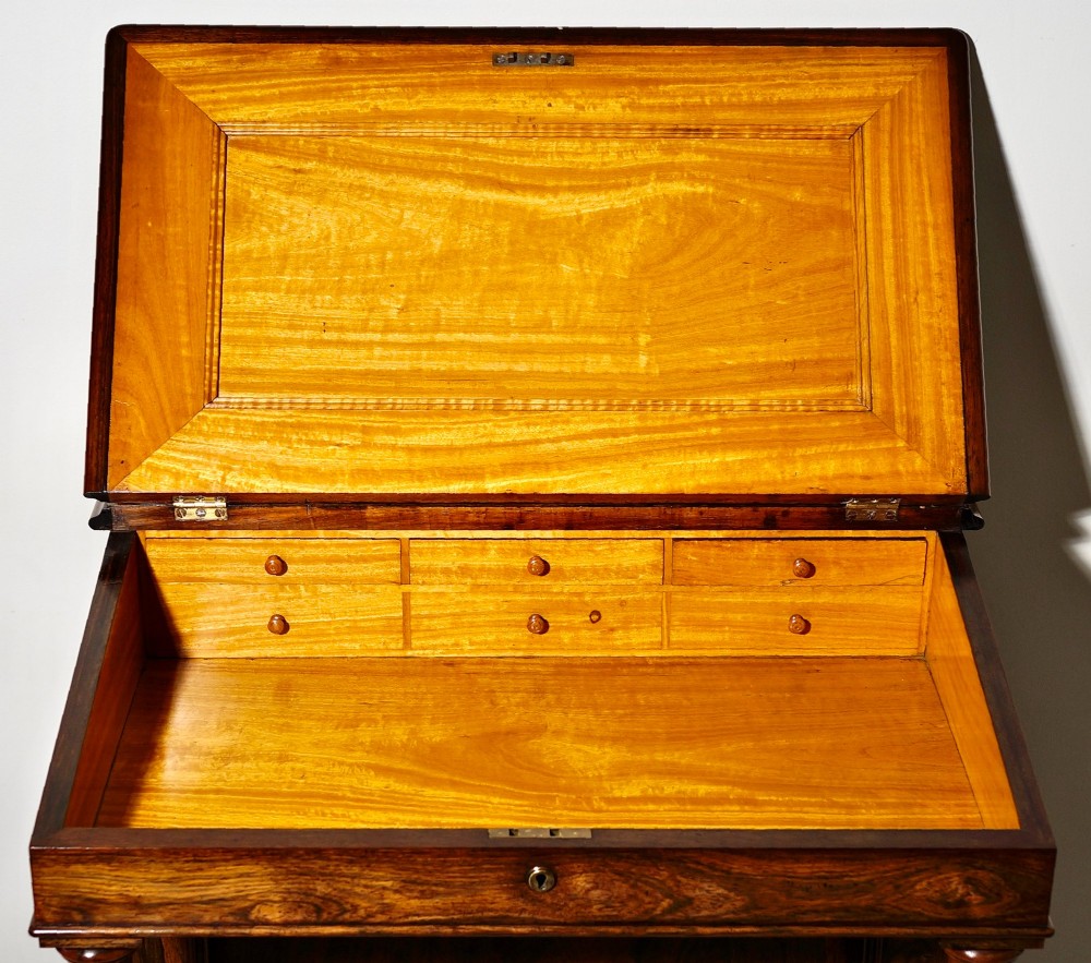 A Victorian rosewood Davenport desk featuring barley twist front supports, side drawers with wooden knob handles, and a hinged slanted top. View VI