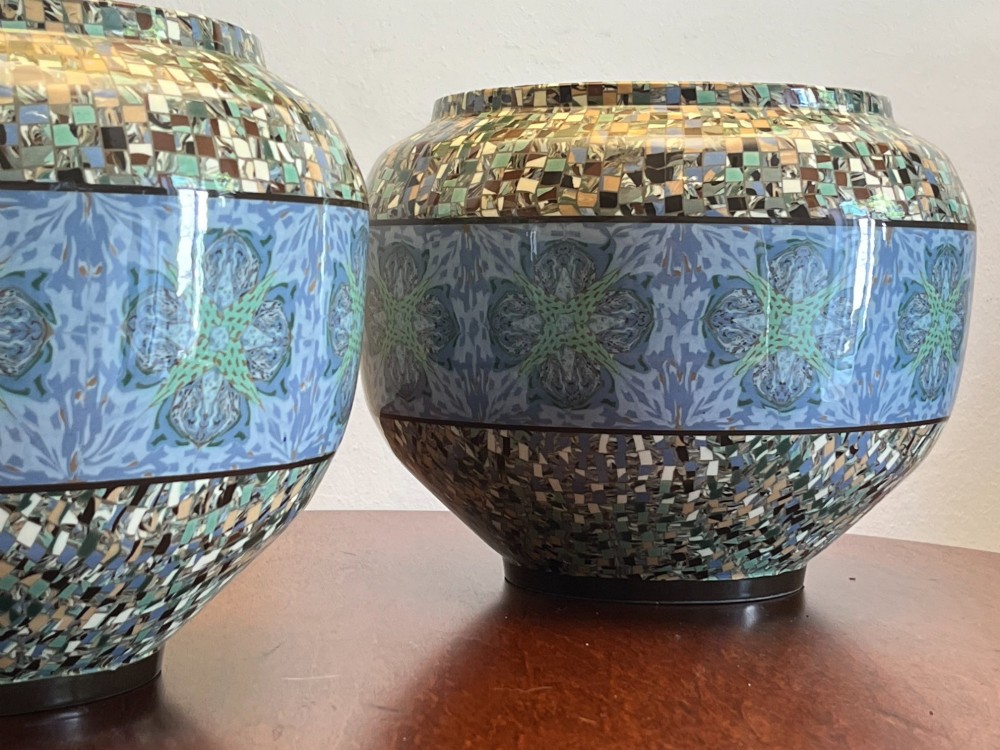 A pair of round ceramic vases with mosaic tile pattern bands around the rim and base and a blue and green stylised floral pattern across the centre. View II