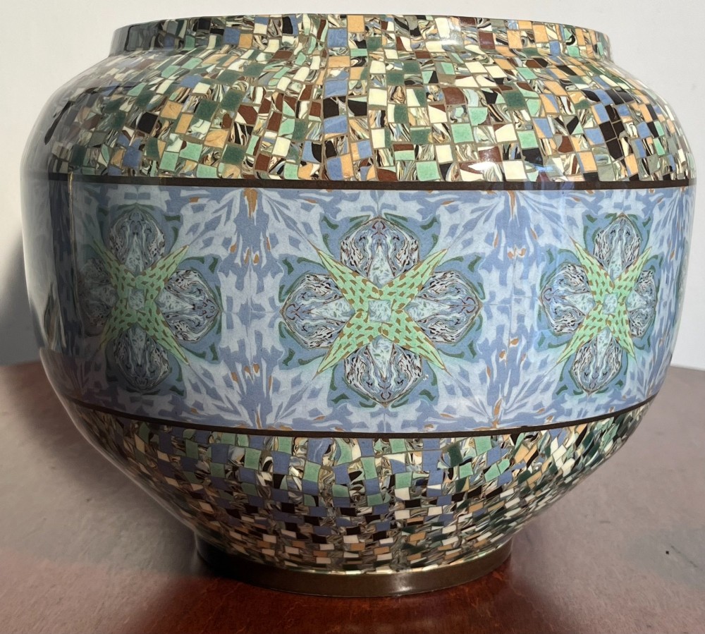 A pair of round ceramic vases with mosaic tile pattern bands around the rim and base and a blue and green stylised floral pattern across the centre. View III