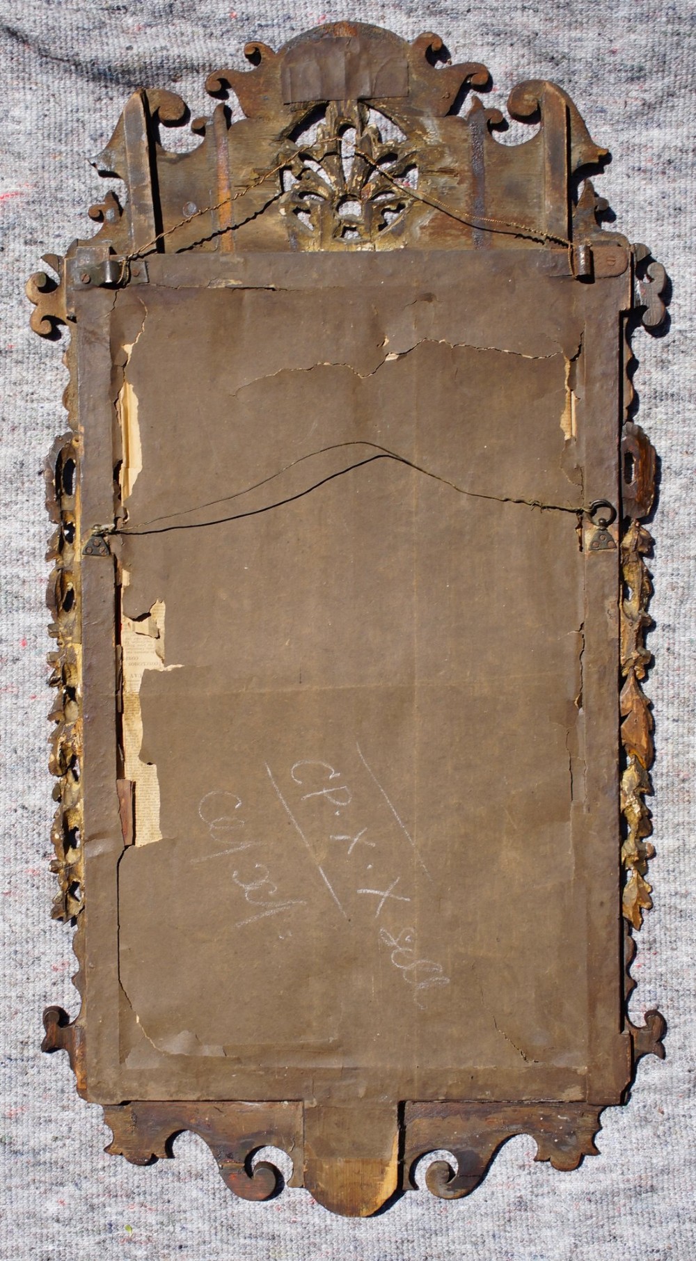 An antique rectangular parcel-gilt walnut wall mirror featuring a fret-cut scrolled frame with gold leaf side garlands and a central carved cresting. View IV