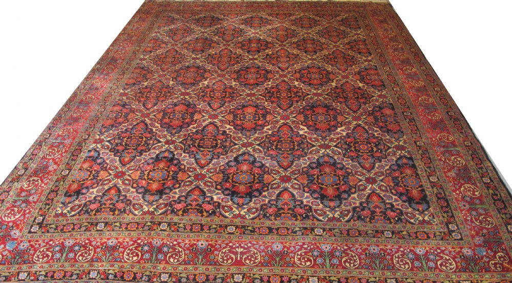 An extra-large hand-knotted Persian wool carpet featuring an intricate floral medallion lattice pattern in red, navy, and cream with an ornate multi-banded border.