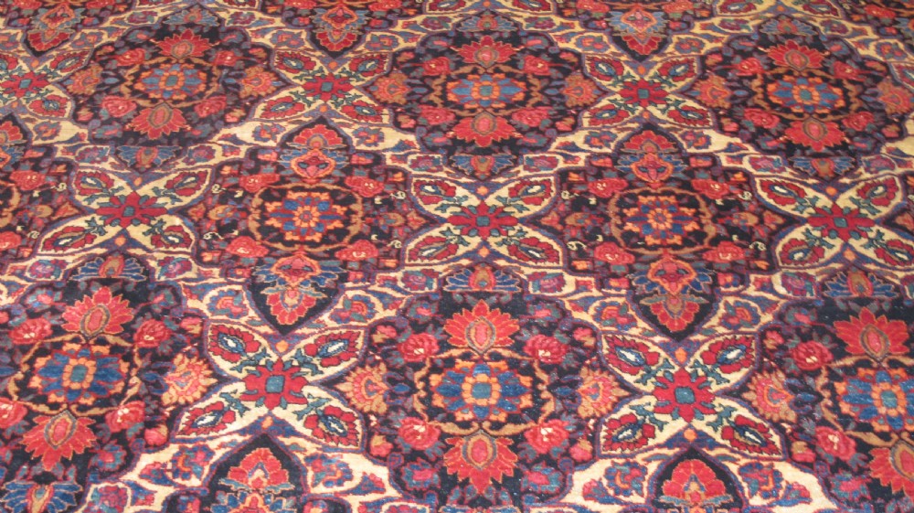 An extra-large hand-knotted Persian wool carpet featuring an intricate floral medallion lattice pattern in red, navy, and cream with an ornate multi-banded border. View II