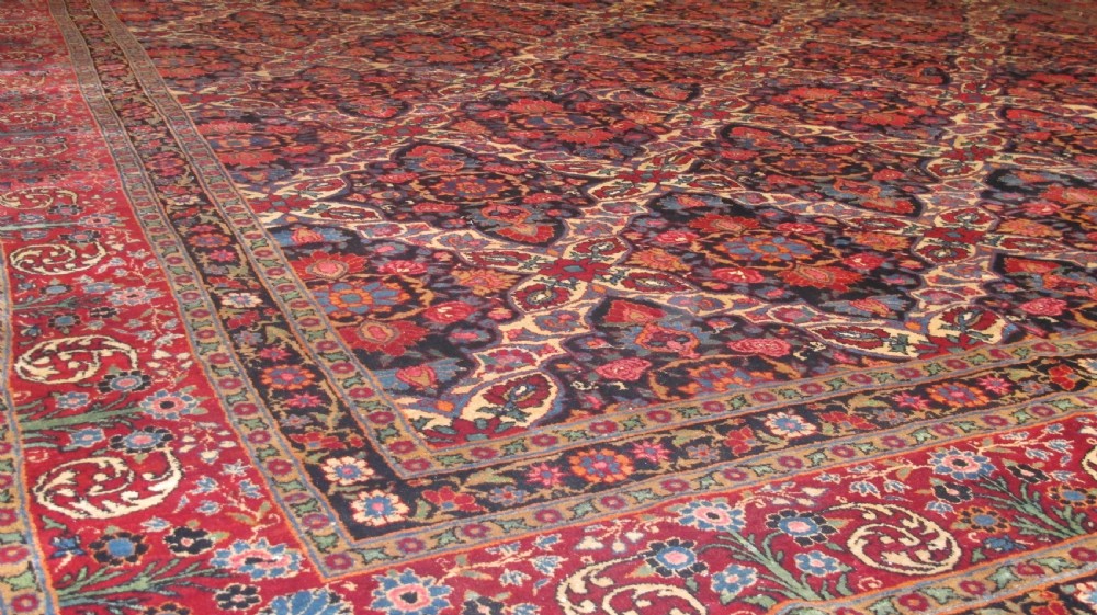 An extra-large hand-knotted Persian wool carpet featuring an intricate floral medallion lattice pattern in red, navy, and cream with an ornate multi-banded border. View III