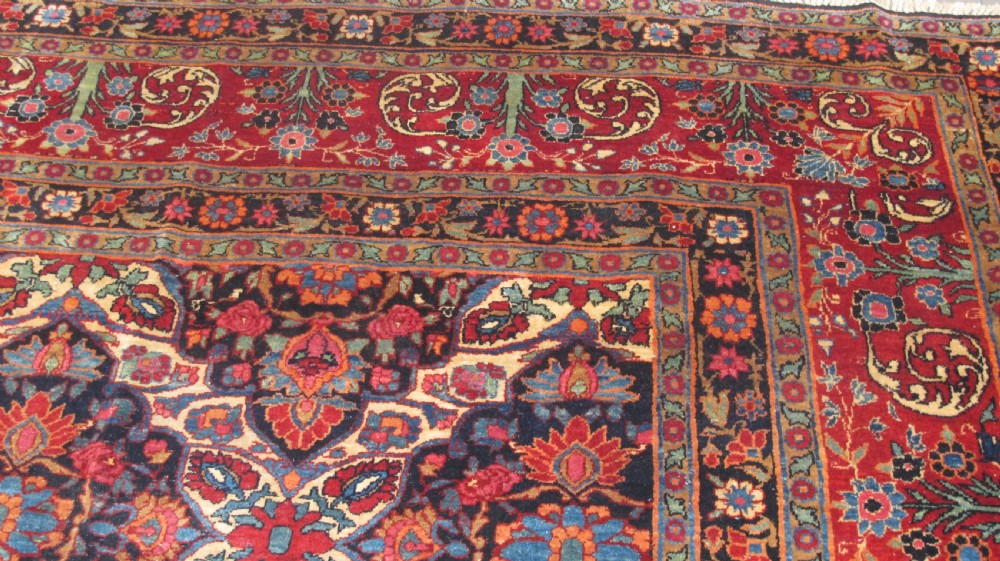 An extra-large hand-knotted Persian wool carpet featuring an intricate floral medallion lattice pattern in red, navy, and cream with an ornate multi-banded border. View V