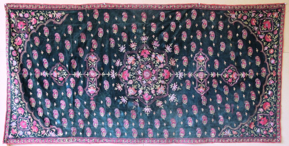 A large rectangular dark green velvet panel featuring intricate pink and gold embroidered floral medallions and boteh patterns.