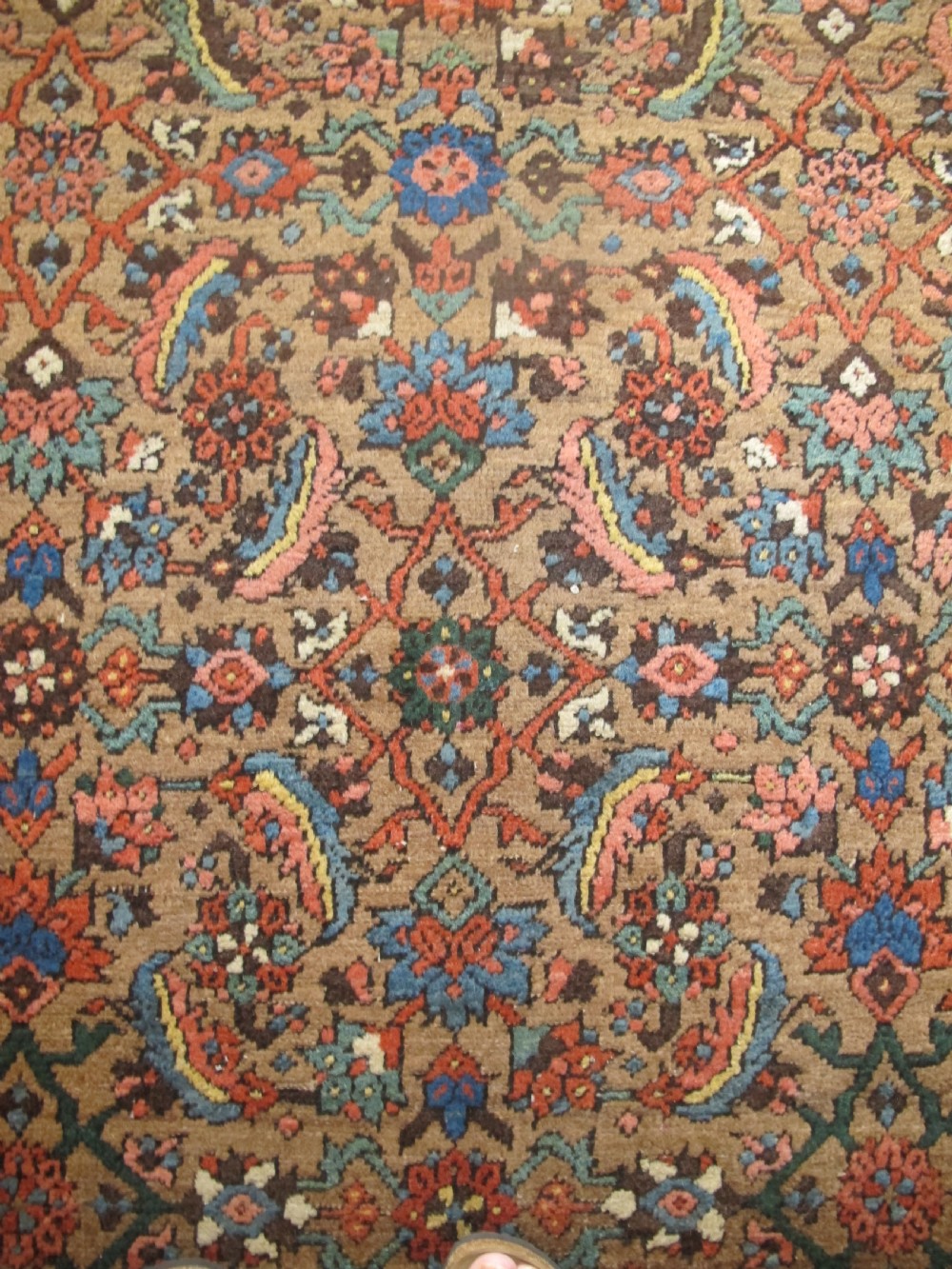 A long hand-knotted antique North-West Persian gallery carpet featuring detailed floral patterns on a camel field with terracotta borders. View II