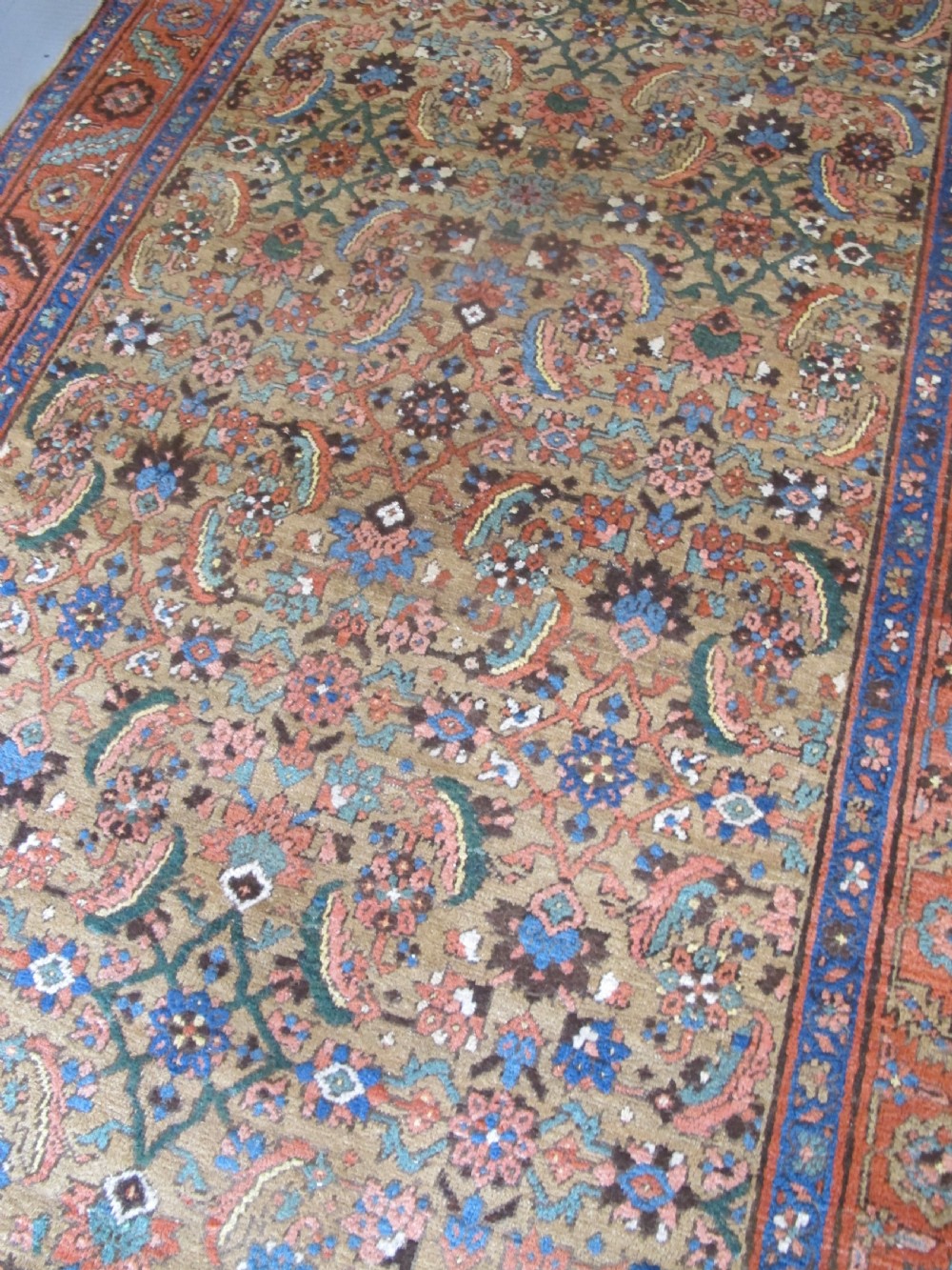A long hand-knotted antique North-West Persian gallery carpet featuring detailed floral patterns on a camel field with terracotta borders. View VIII