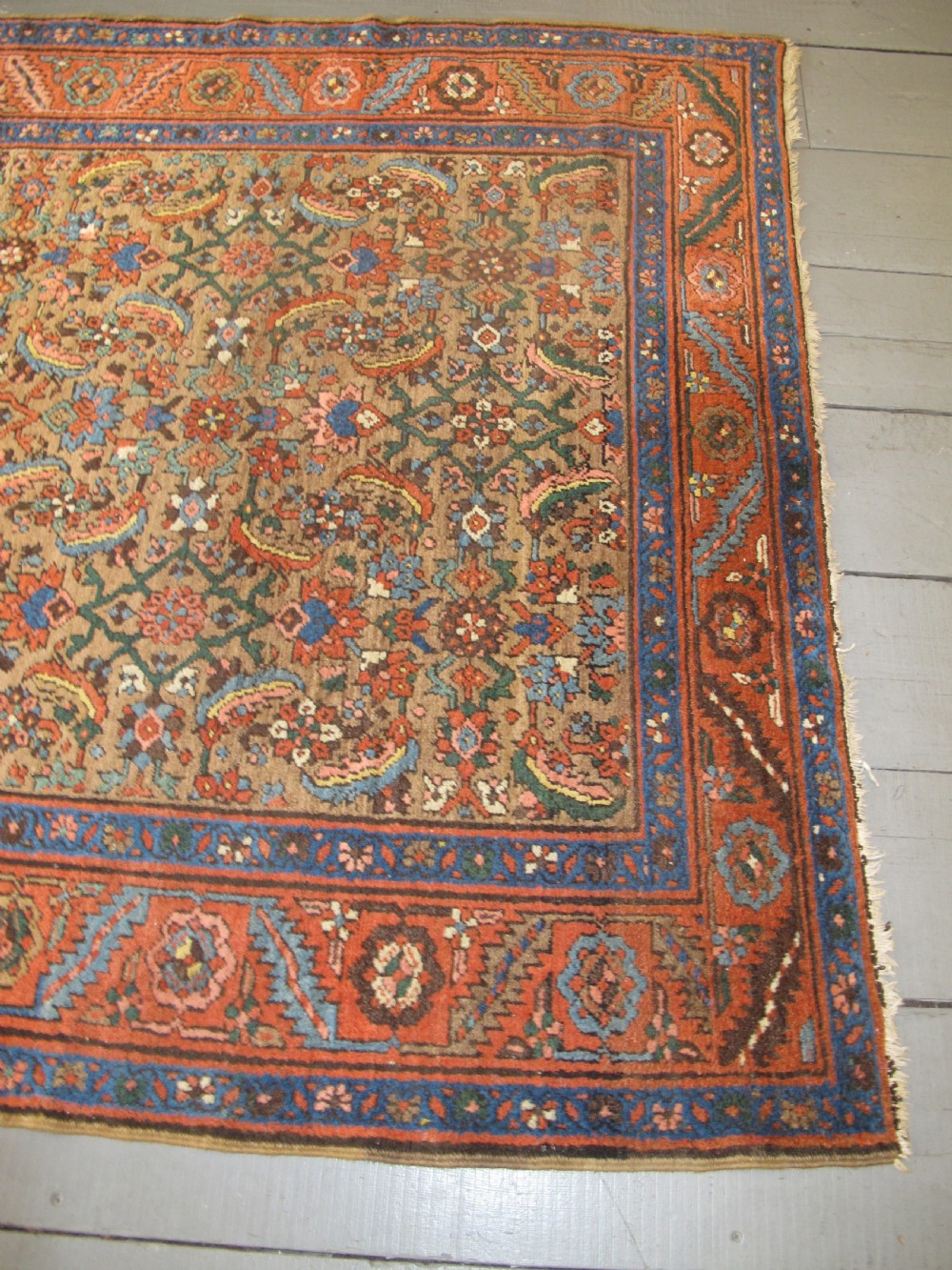 A long hand-knotted antique North-West Persian gallery carpet featuring detailed floral patterns on a camel field with terracotta borders. View XI