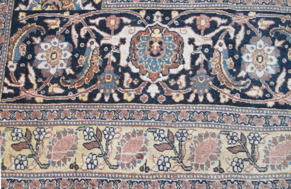 An oversized antique Haji Jalili Tabriz wool carpet featuring a central star-shaped medallion, intricate floral field, cream corner spandrels, and a multi-bordered pattern. View II