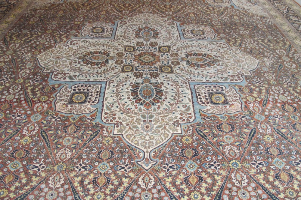 An oversized antique Haji Jalili Tabriz wool carpet featuring a central star-shaped medallion, intricate floral field, cream corner spandrels, and a multi-bordered pattern. View III