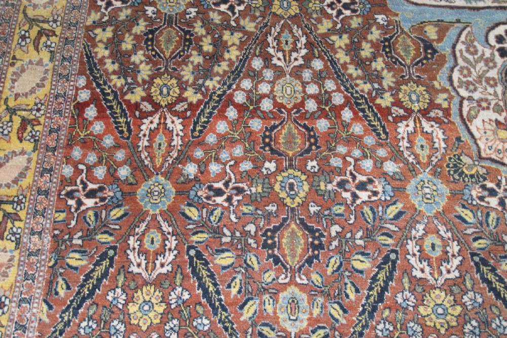 An oversized antique Haji Jalili Tabriz wool carpet featuring a central star-shaped medallion, intricate floral field, cream corner spandrels, and a multi-bordered pattern. View V