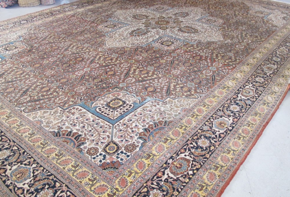 An oversized antique Haji Jalili Tabriz wool carpet featuring a central star-shaped medallion, intricate floral field, cream corner spandrels, and a multi-bordered pattern. View VI