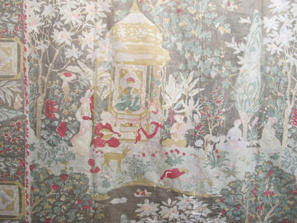 A rectangular 19th-century Persian Qajar block-printed and hand-painted cotton textile displaying cypress trees, garden pavilions, and seated figures within a wide decorative border. View II