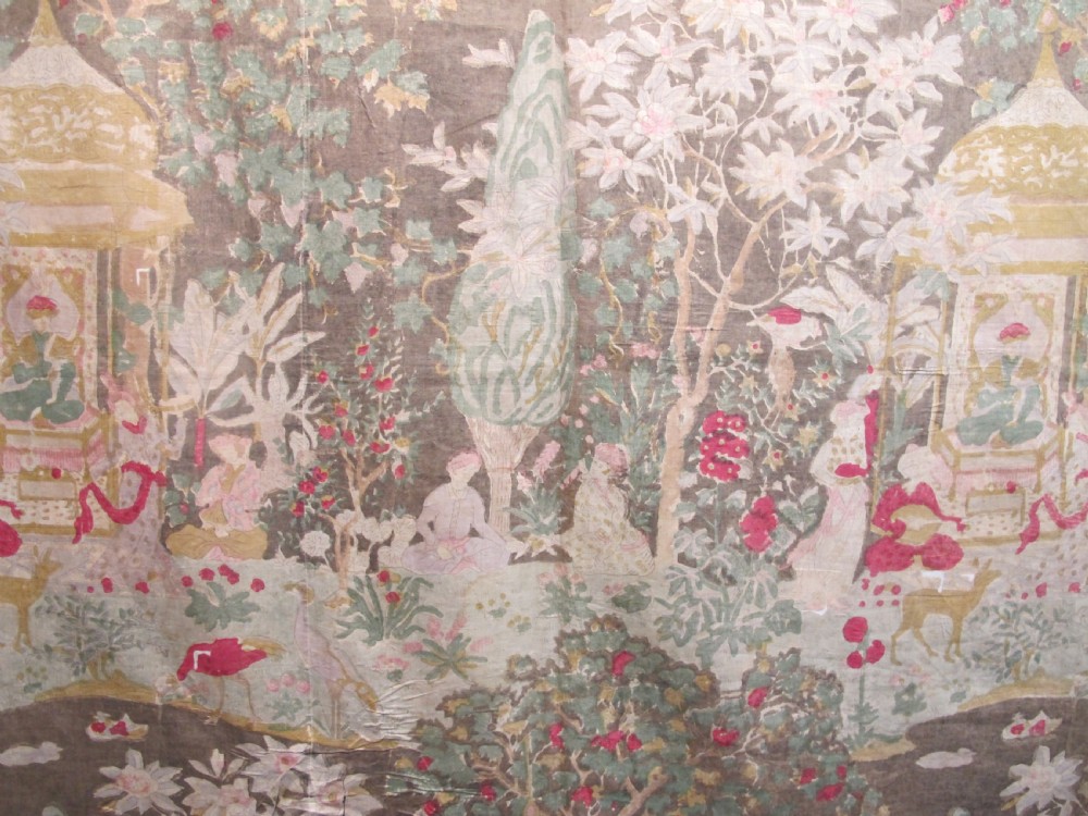 A rectangular 19th-century Persian Qajar block-printed and hand-painted cotton textile displaying cypress trees, garden pavilions, and seated figures within a wide decorative border. View III