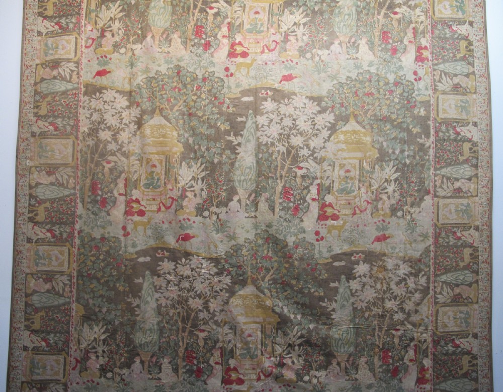 A rectangular 19th-century Persian Qajar block-printed and hand-painted cotton textile displaying cypress trees, garden pavilions, and seated figures within a wide decorative border. View IV