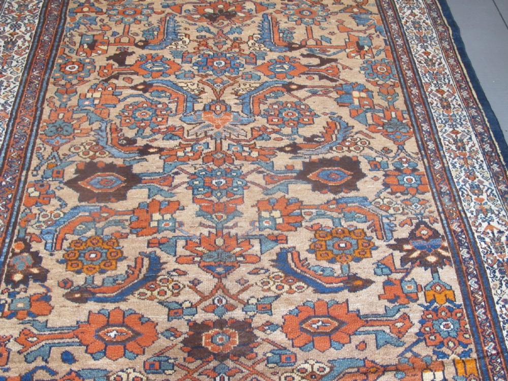 An antique hand-knotted Hamadan carpet featuring intricate geometric and floral patterns in terracotta, indigo blue, and tan hues. View II