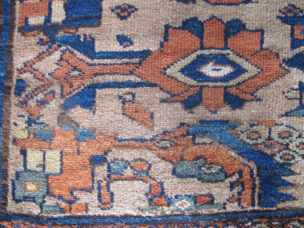 An antique hand-knotted Hamadan carpet featuring intricate geometric and floral patterns in terracotta, indigo blue, and tan hues. View IV