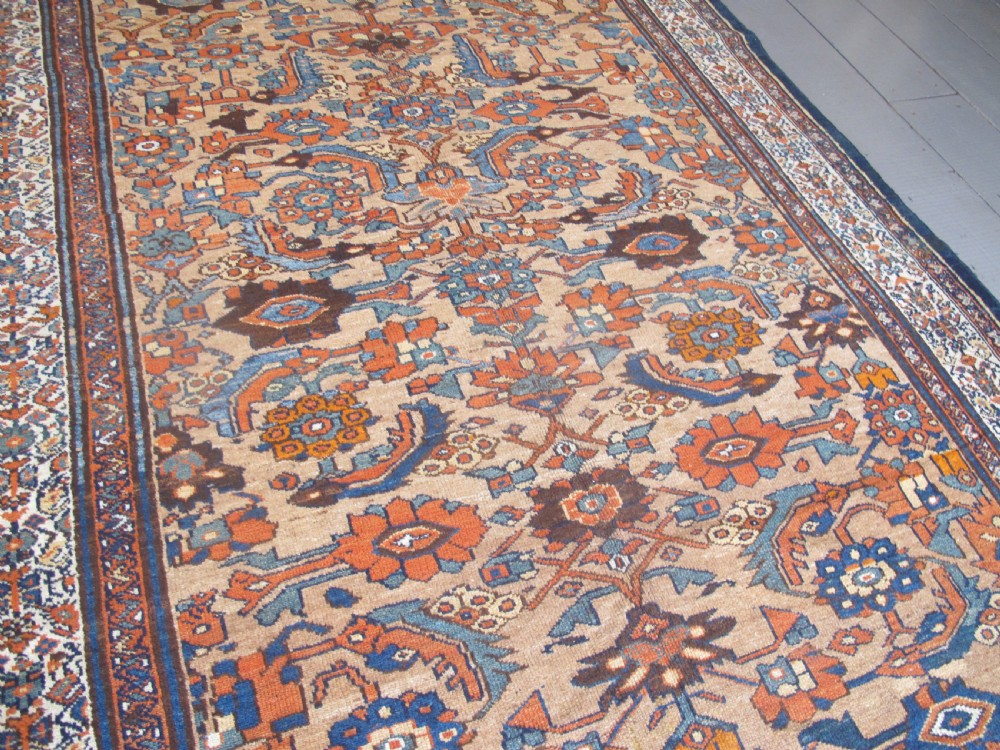 An antique hand-knotted Hamadan carpet featuring intricate geometric and floral patterns in terracotta, indigo blue, and tan hues. View IX