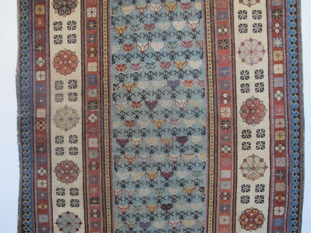 An antique Caucasian Talish hand-knotted wool long rug featuring a light blue central field with geometric motifs bordered by ivory and red patterned bands. View II