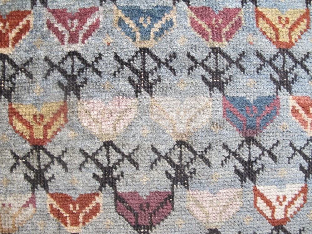 An antique Caucasian Talish hand-knotted wool long rug featuring a light blue central field with geometric motifs bordered by ivory and red patterned bands. View III