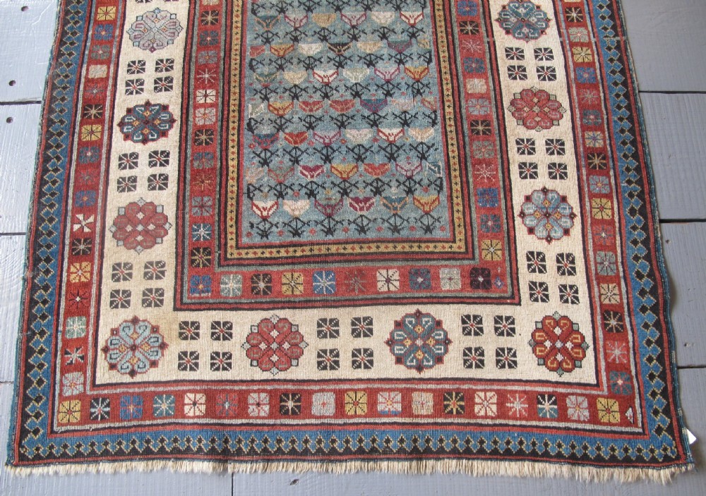 An antique Caucasian Talish hand-knotted wool long rug featuring a light blue central field with geometric motifs bordered by ivory and red patterned bands. View IV