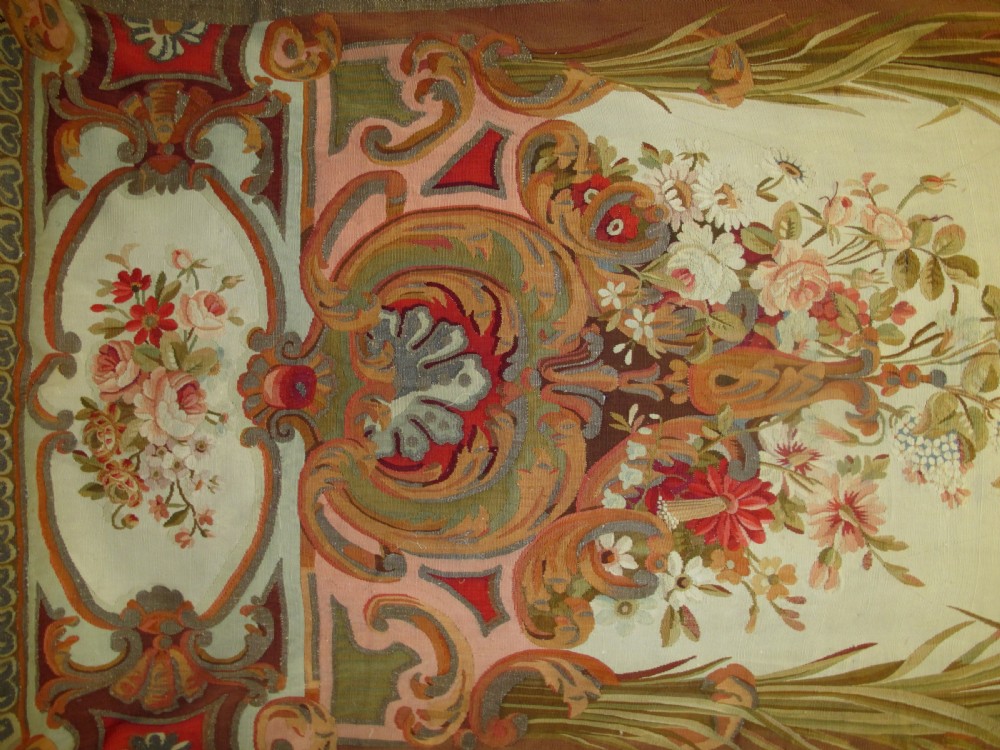 A tall, narrow 19th-century French Aubusson woven tapestry featuring a hanging floral basket, urn motifs, and rocaille border designs on a beige ground. View III