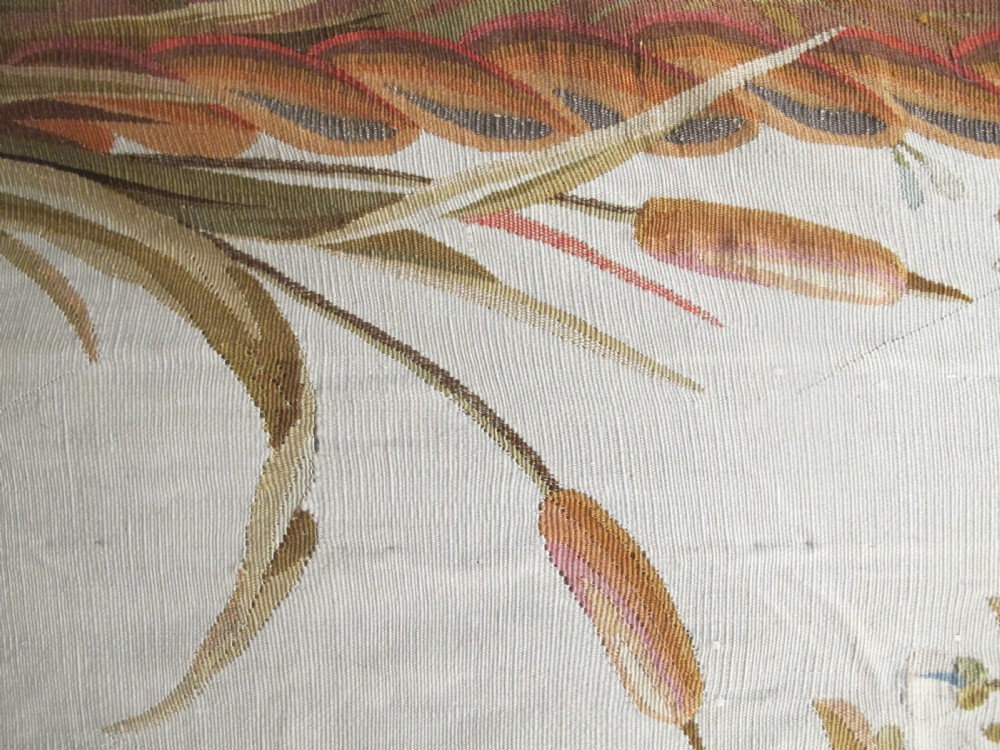 A tall, narrow 19th-century French Aubusson woven tapestry featuring a hanging floral basket, urn motifs, and rocaille border designs on a beige ground. View VI