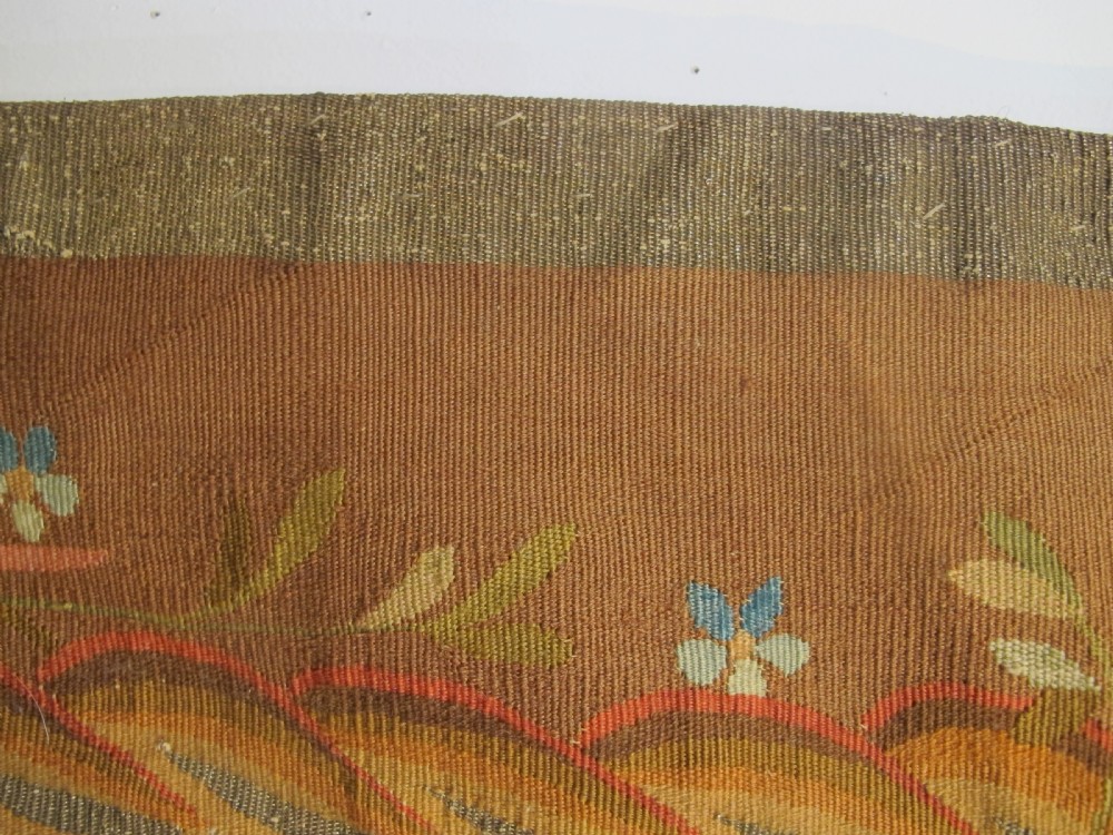 A tall, narrow 19th-century French Aubusson woven tapestry featuring a hanging floral basket, urn motifs, and rocaille border designs on a beige ground. View VII