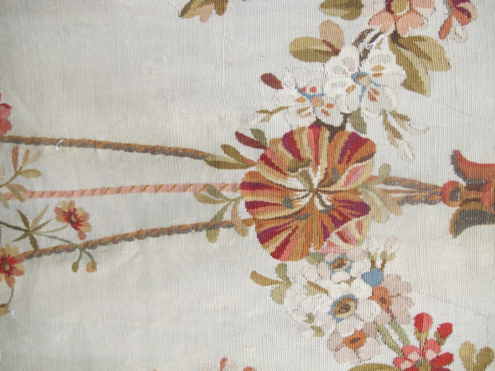 A tall, narrow 19th-century French Aubusson woven tapestry featuring a hanging floral basket, urn motifs, and rocaille border designs on a beige ground. View VIII