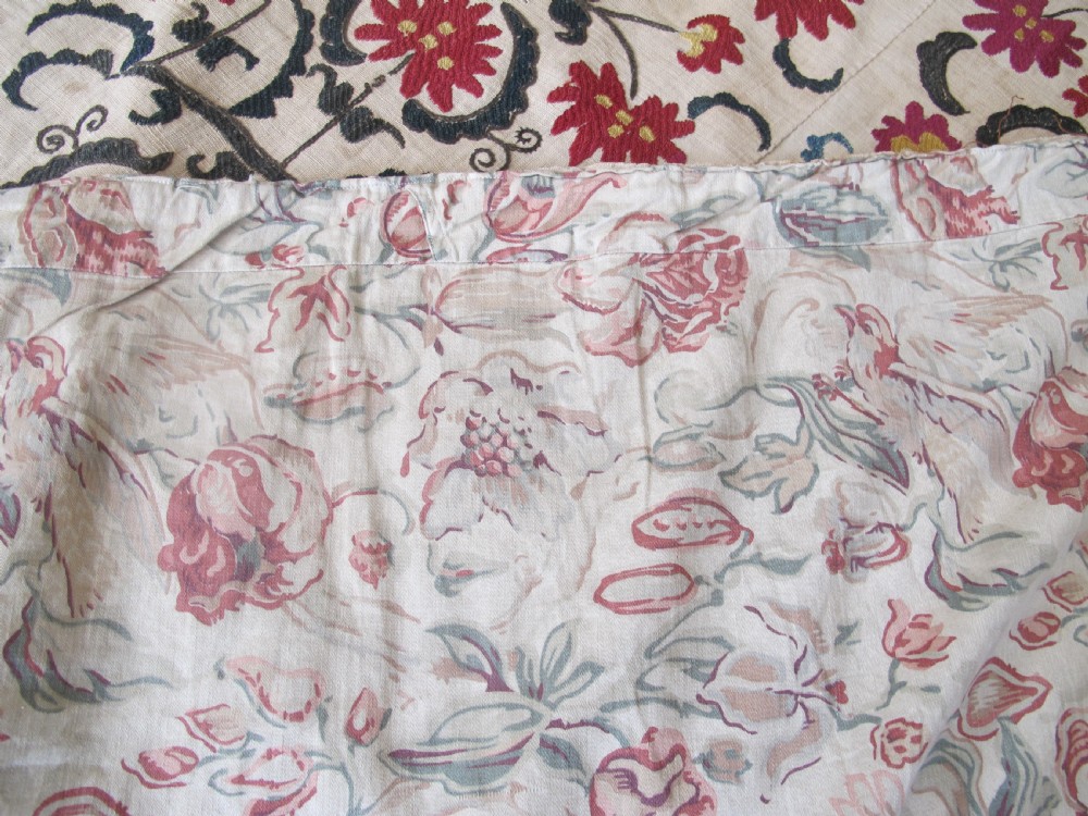 A large rectangular Central Asian suzani textile featuring repeating vertical columns of red embroidered floral motifs on a natural beige cotton substrate. View IX