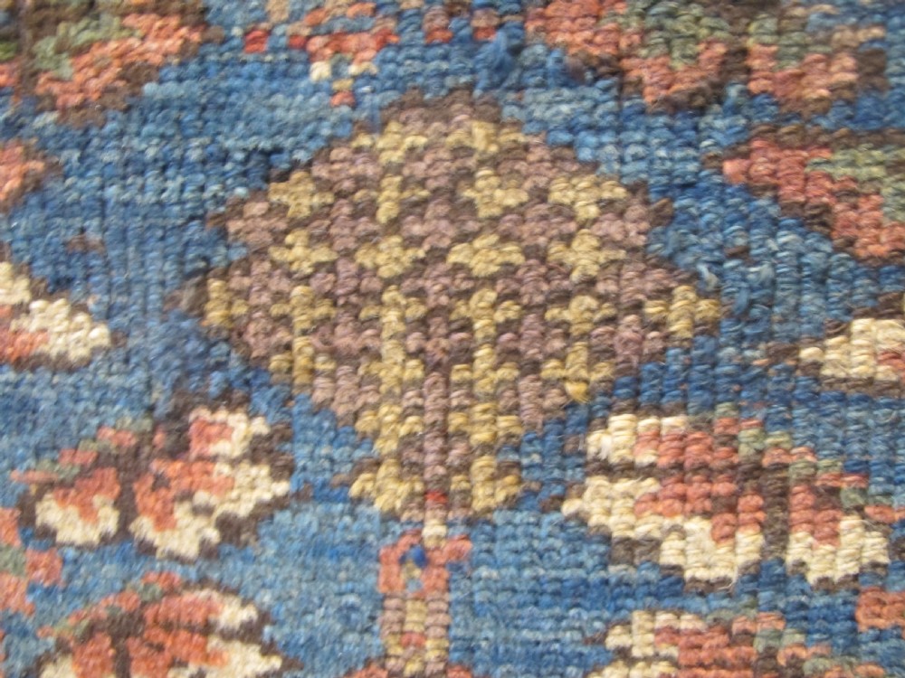 An antique hand-knotted West Persian Kurdish wool runner rug featuring repeating geometric motifs on a dark blue field framed by a patterned ochre border. View VIII