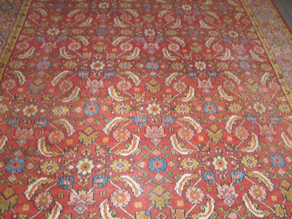 A large 19th-century antique Persian Mahal carpet featuring a terracotta red field with repeating floral lattice motifs and broad multi-tiered decorative borders. View II