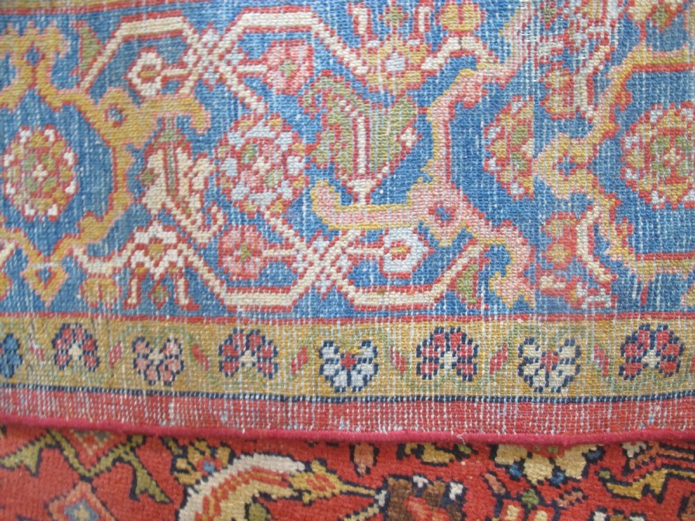 A large 19th-century antique Persian Mahal carpet featuring a terracotta red field with repeating floral lattice motifs and broad multi-tiered decorative borders. View X