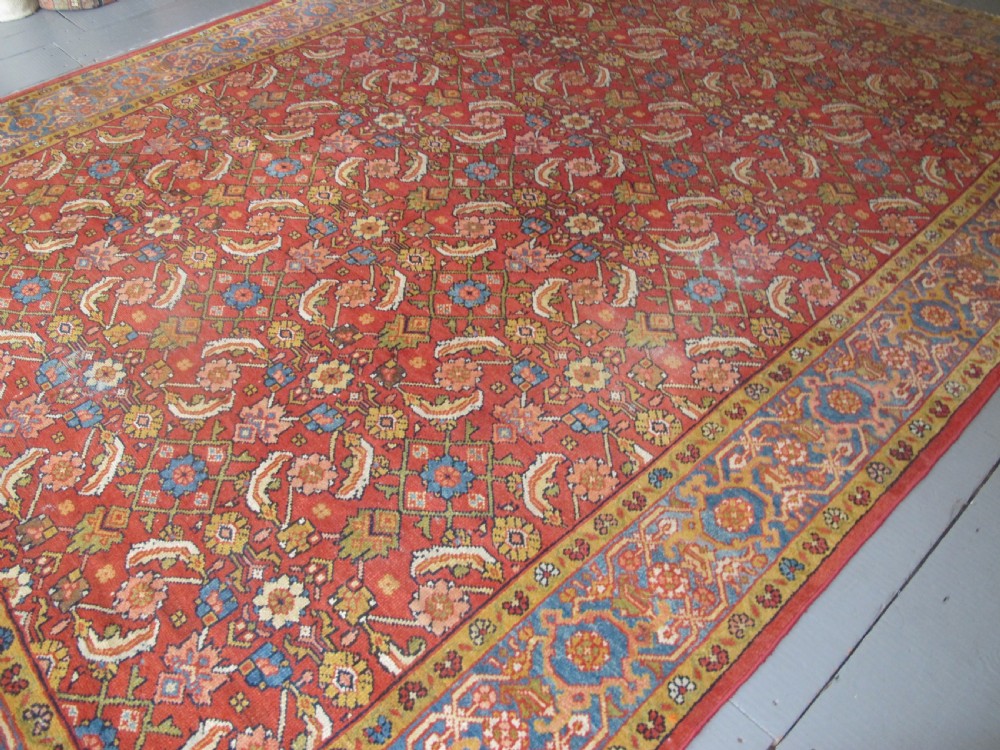 A large 19th-century antique Persian Mahal carpet featuring a terracotta red field with repeating floral lattice motifs and broad multi-tiered decorative borders. View XI