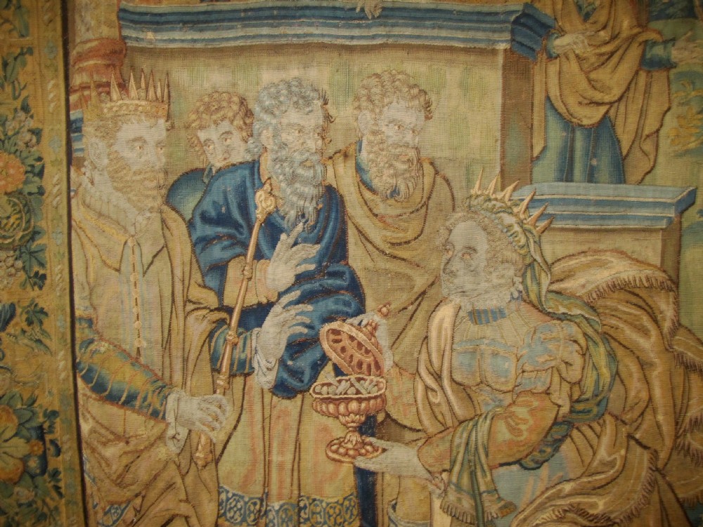 A large 16th-century Flemish Renaissance tapestry woven with figures in classical attire framed by an elaborate floral and fruit border. View III