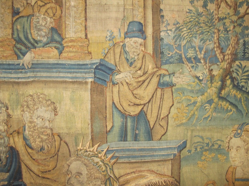 A large 16th-century Flemish Renaissance tapestry woven with figures in classical attire framed by an elaborate floral and fruit border. View VI