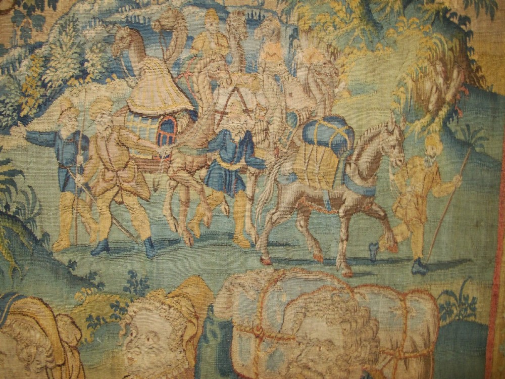 A large 16th-century Flemish Renaissance tapestry woven with figures in classical attire framed by an elaborate floral and fruit border. View VII
