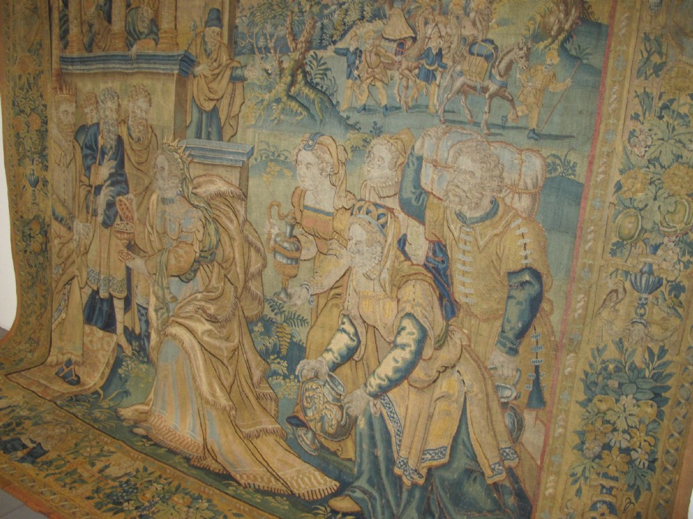 A large 16th-century Flemish Renaissance tapestry woven with figures in classical attire framed by an elaborate floral and fruit border. View VIII