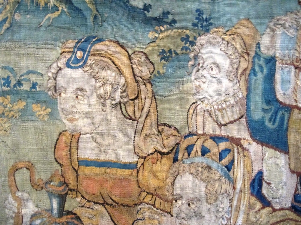 A large 16th-century Flemish Renaissance tapestry woven with figures in classical attire framed by an elaborate floral and fruit border. View XIII