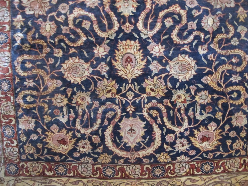 A mid-20th-century Turkish silk rug featuring a dark navy mihrab arch filled with floral motifs, surrounded by an ochre border with calligraphic script and bird illustrations. View II