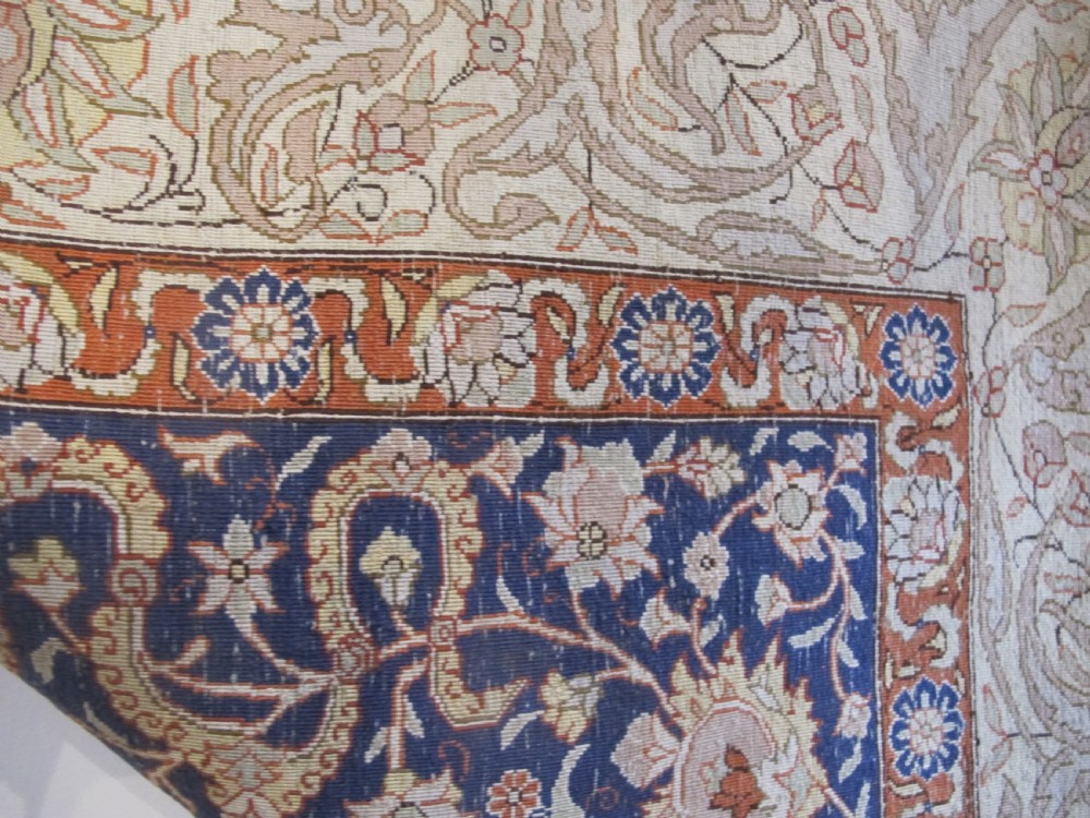 A mid-20th-century Turkish silk rug featuring a dark navy mihrab arch filled with floral motifs, surrounded by an ochre border with calligraphic script and bird illustrations. View XI