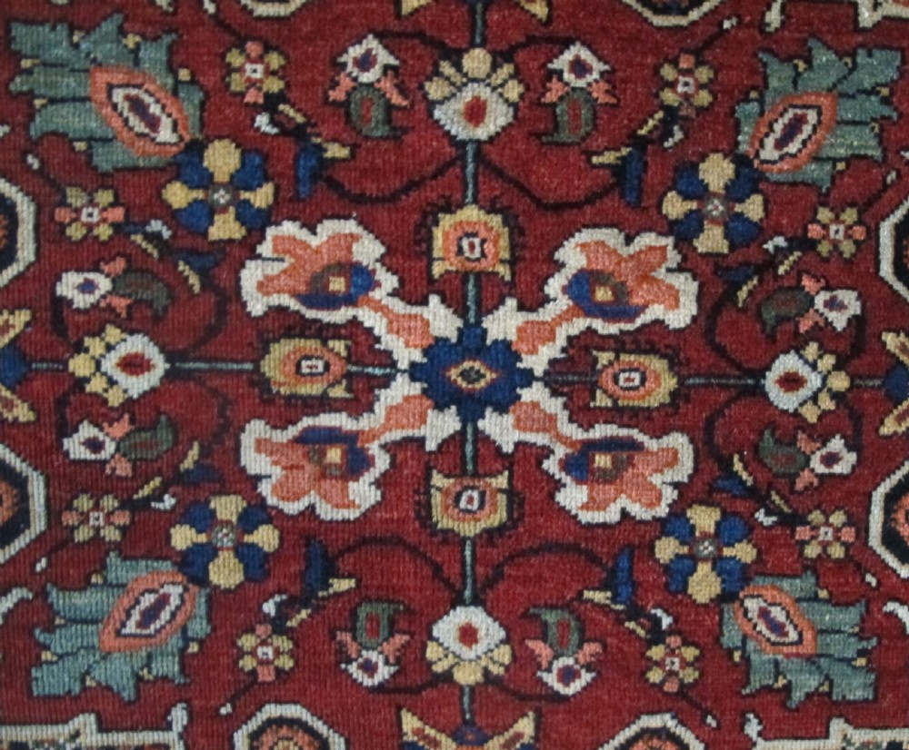 An antique hand-knotted Persian Fereghan wool rug featuring a central terracotta diamond medallion set within a dense navy blue floral field and ornate multi-layered borders. View VIII