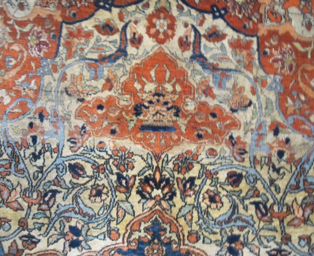 An antique hand-knotted Persian Isfahan rug featuring a central floral medallion surrounded by arabesque scrollwork and detailed multi-banded borders in terracotta red, navy blue, and cream. View XI