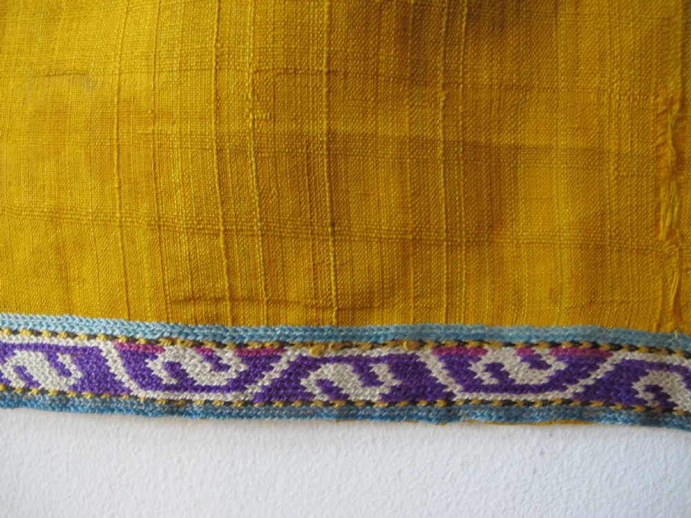 An early 20th-century yellow silk textile from Uzbekistan featuring hand-embroidered floral motifs, a central arch design, and calligraphic borders. View XI