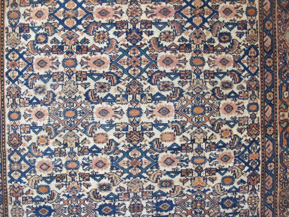 A rectangular antique Persian Fereghan rug with a detailed cream, terracotta, and navy Herati pattern bordered by intricate geometric bands. View II