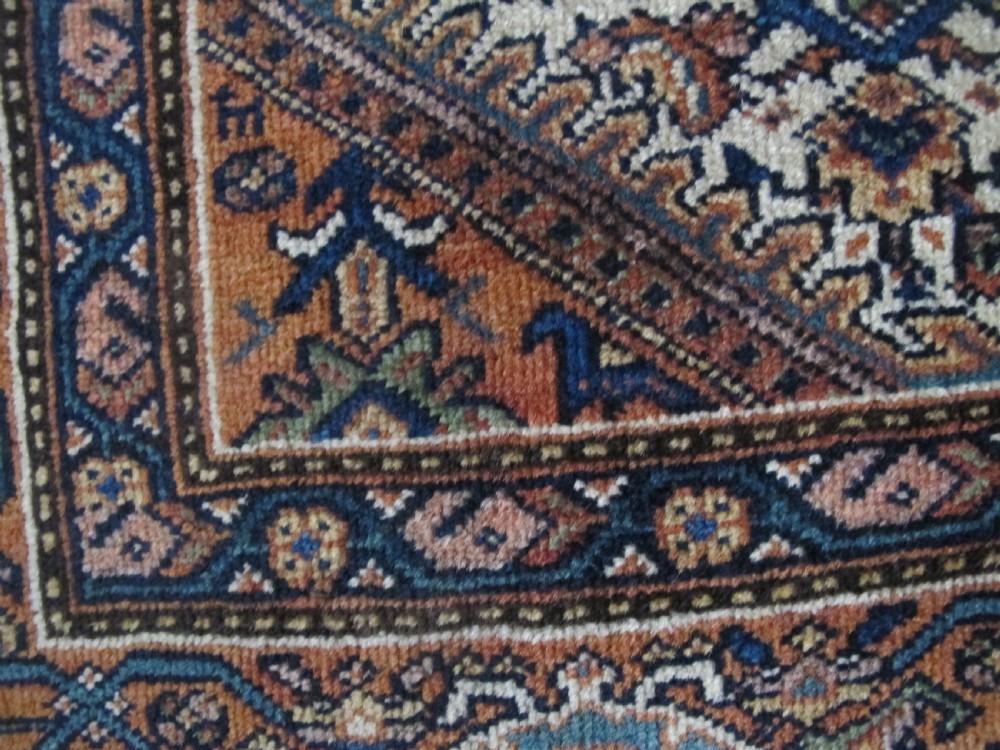 A rectangular antique Persian Fereghan rug with a detailed cream, terracotta, and navy Herati pattern bordered by intricate geometric bands. View VII