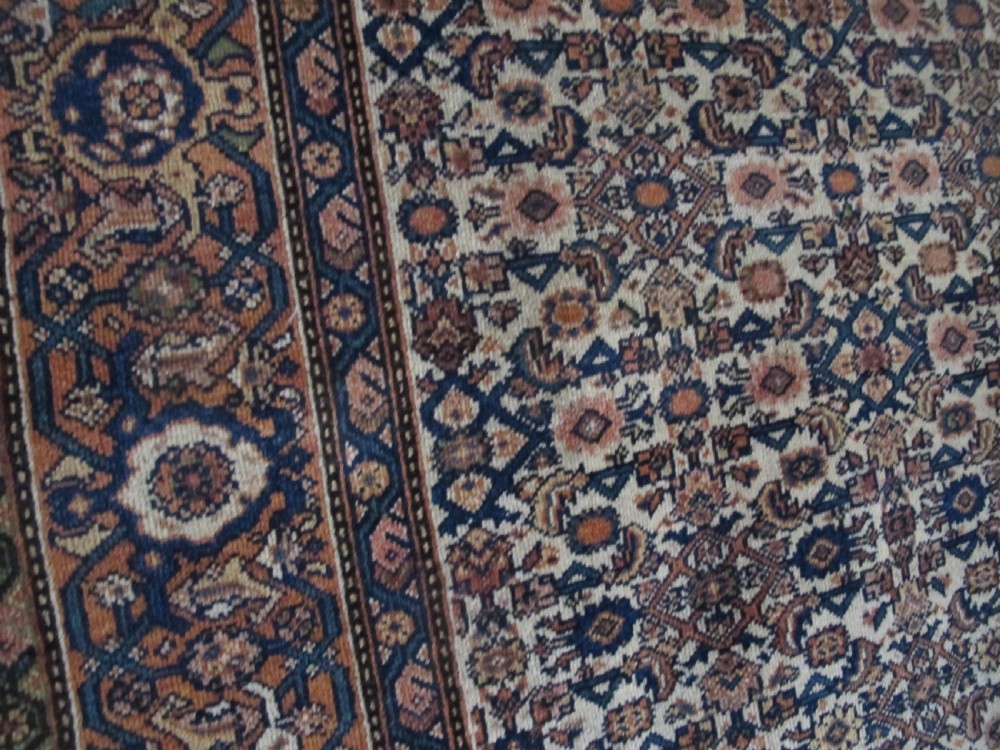 A rectangular antique Persian Fereghan rug with a detailed cream, terracotta, and navy Herati pattern bordered by intricate geometric bands. View XI